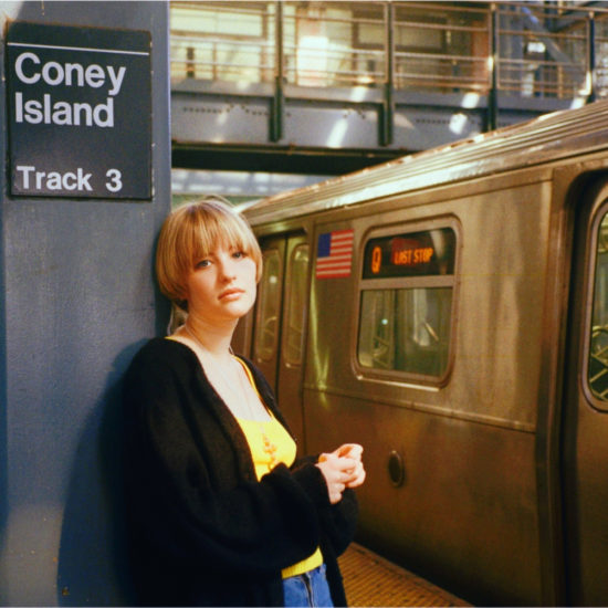 A woman with a black jacket at a train station