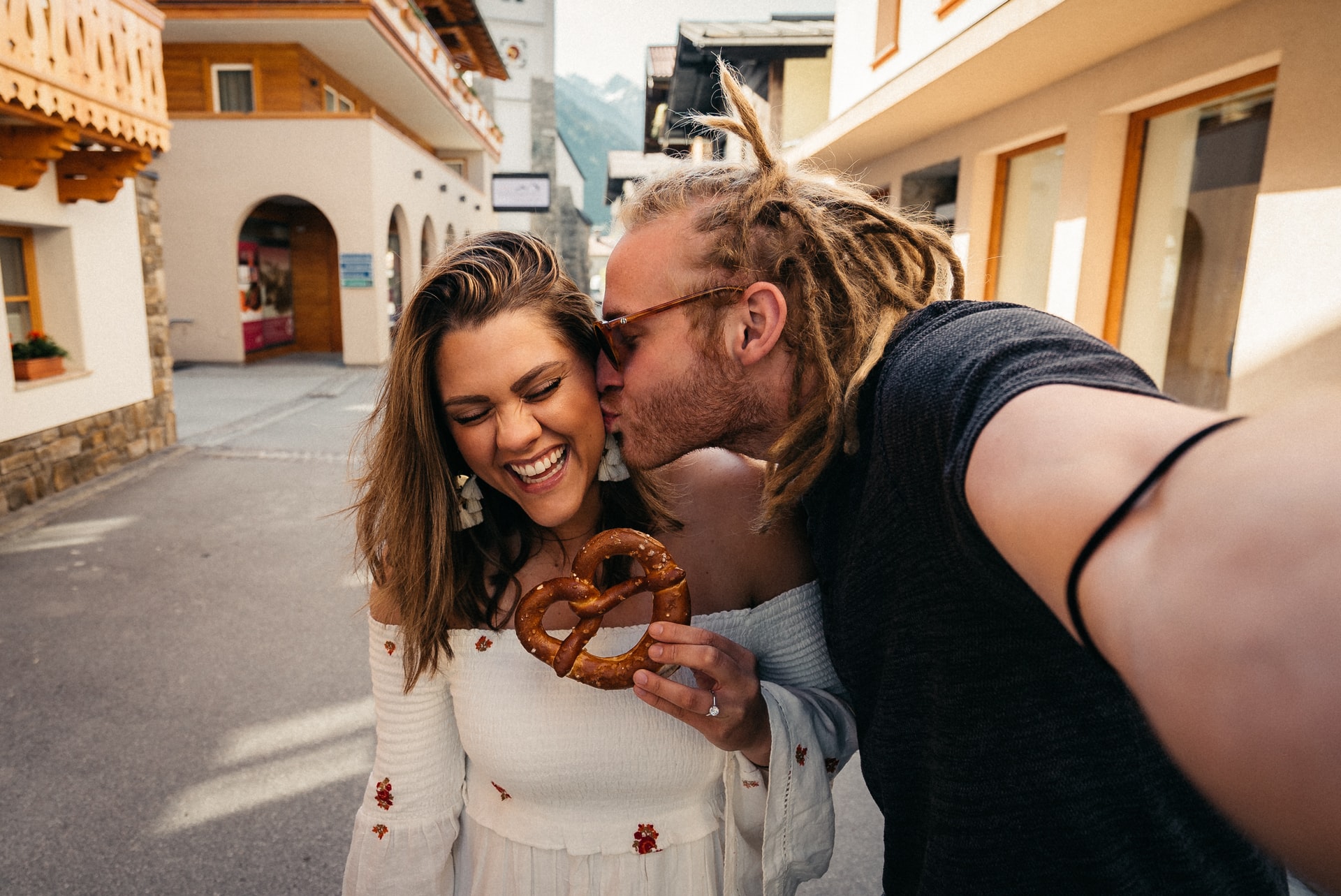 A man kisses a woman on a magical street