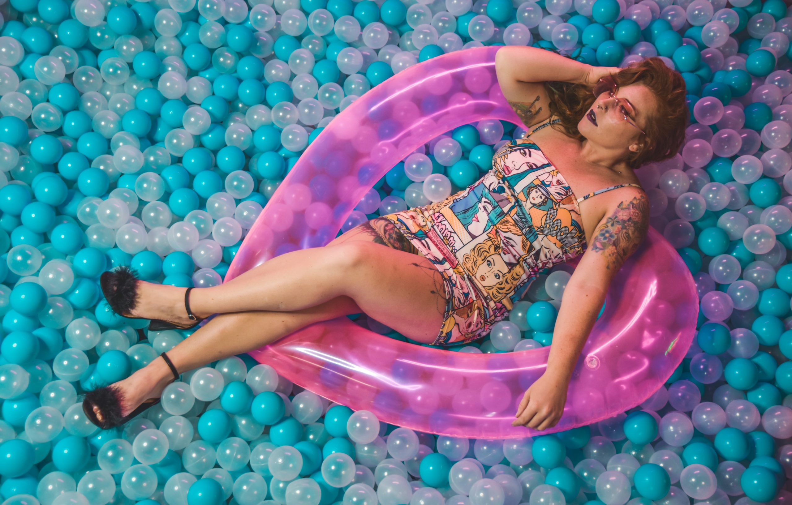 A woman on a ferris wheel in a pool of balls