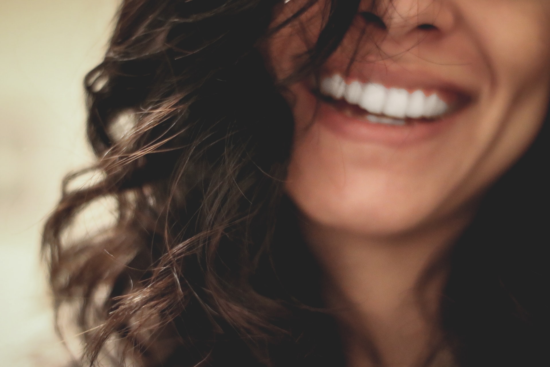 Close-up of woman smiling with white teeth.