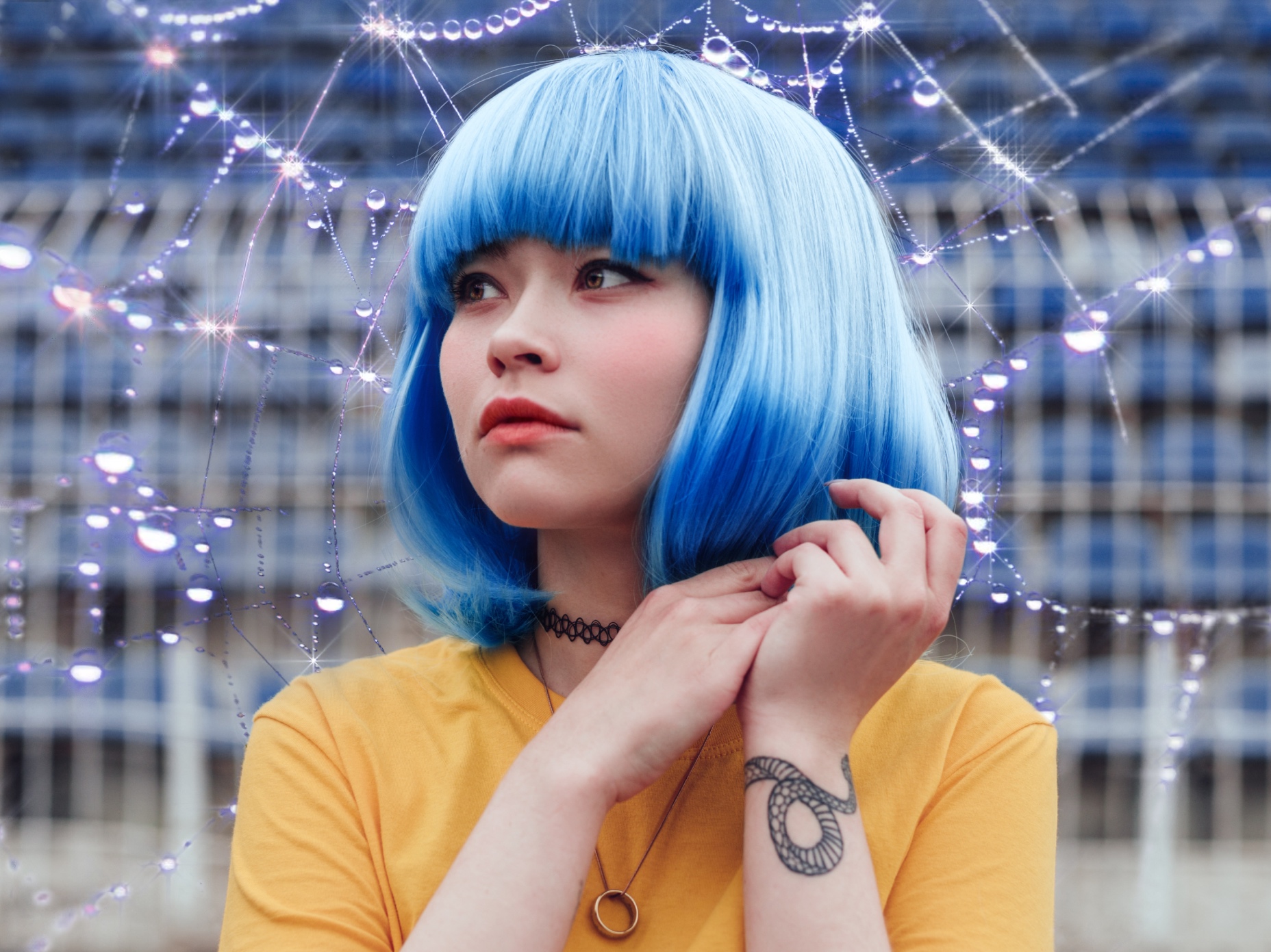 A woman with a yellow shirt and blue hair