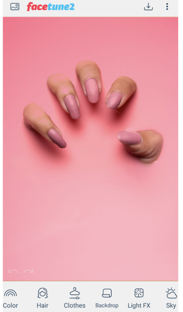 Palm on pink nail polish on a pink background