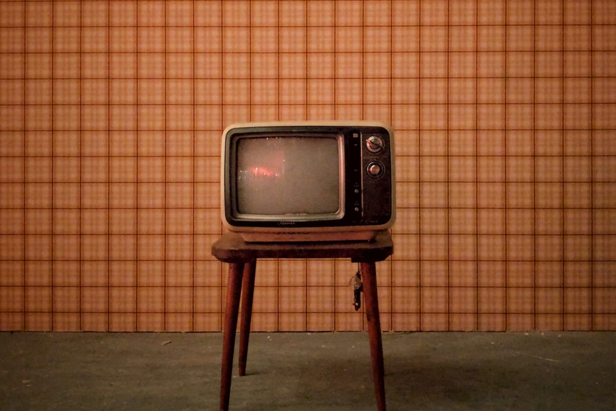 An old TV on a wooden stool